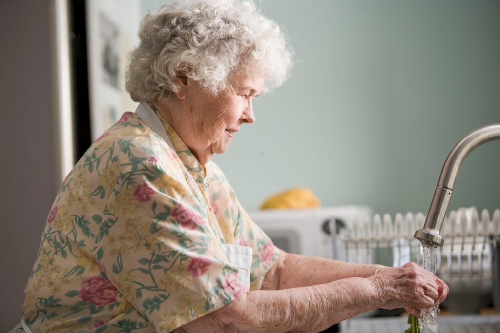 Older woman washing produce